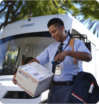 Mail carrier scanning a label on a shipping box.